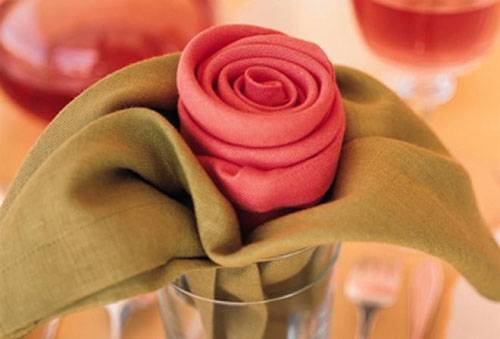 Serviettes pliées comme une rose dans un verre