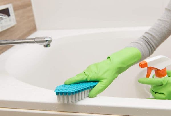 Nettoyer la baignoire avec une brosse