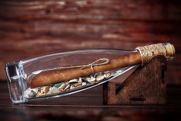 Lettre stylisée dans une bouteille