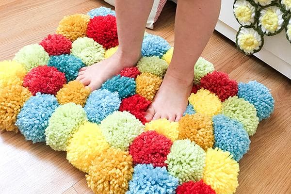 Tapis composé de pompons colorés