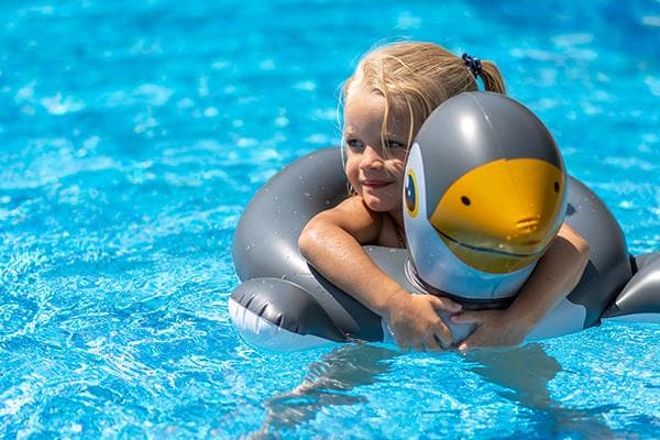 Fille avec un anneau gonflable dans la piscine